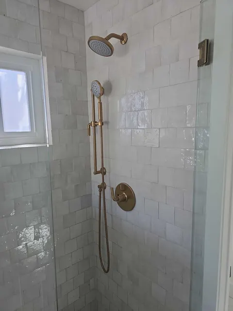 Handmade zellige tile shower with unlacquered brass fixtures