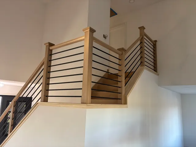 Custom stair railing with white oak posts and horizontal metal balusters