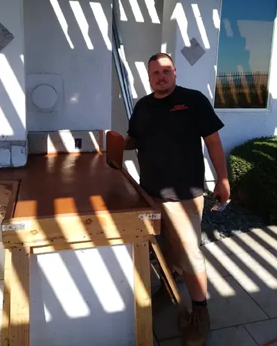Donny Mohr, owner of Mohr Construction, on site building a poured concrete outdoor kitchen counter